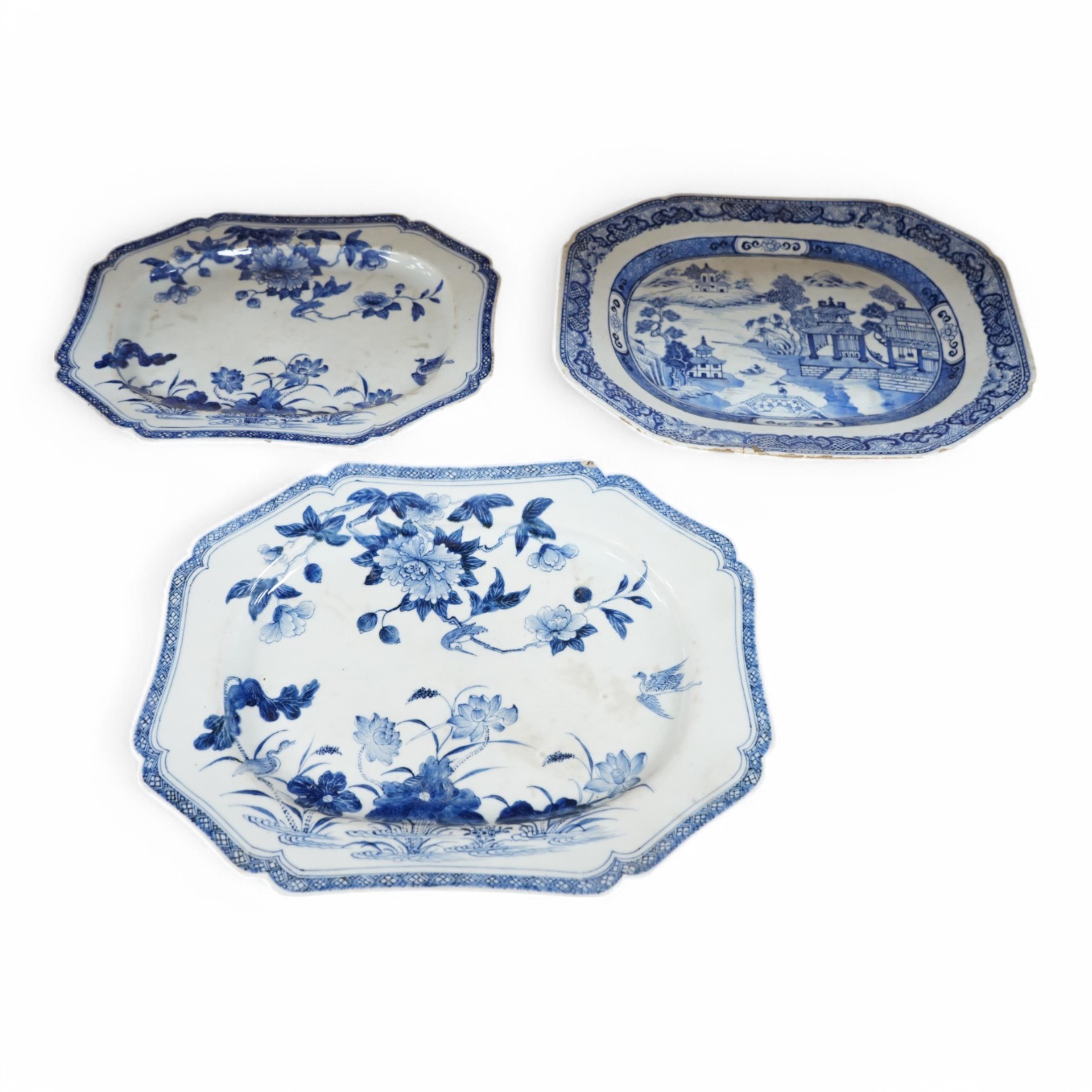 Three 18th century Chinese export blue and white dishes, two decorated with Lotus and peonies, the third with figures in a river landscape scene, Condition - fair to good